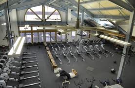 A man exercising in a gym, emphasizing the role of exercise in health and rehabilitation.