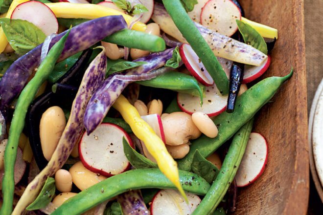 Colorful assortment of fresh vegetables including carrots, bell peppers, tomatoes, and green leafy vegetables, arranged neatly, symbolizing healthy eating and nutrition.