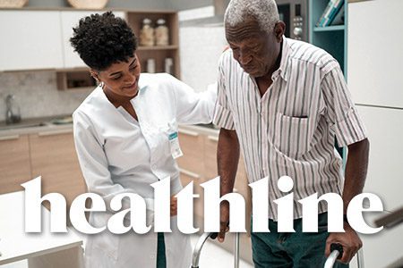 A nurse assisting an older man in a kitchin, depicting patient support services. Text overlays the image, stating 'Healthline.'